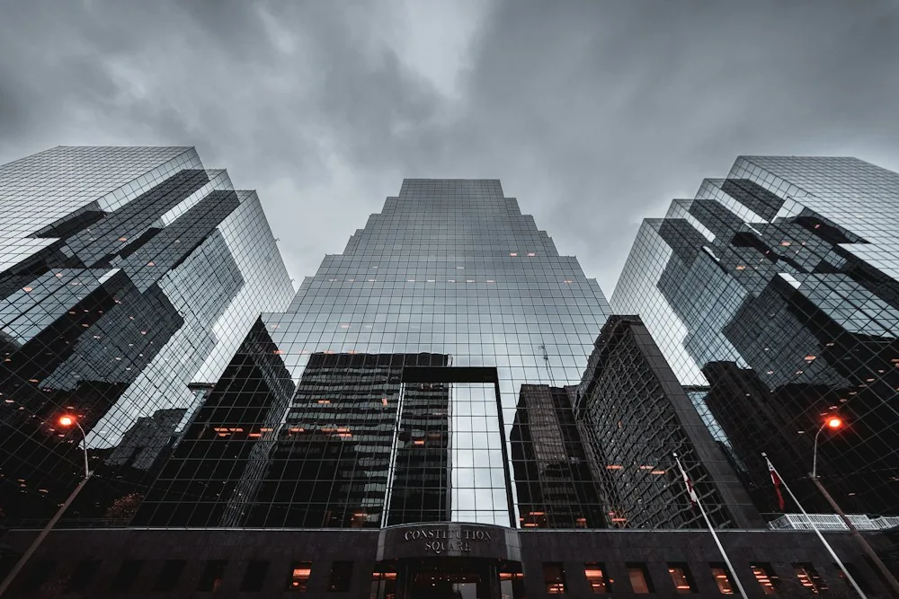Modern glass towers seen from street level