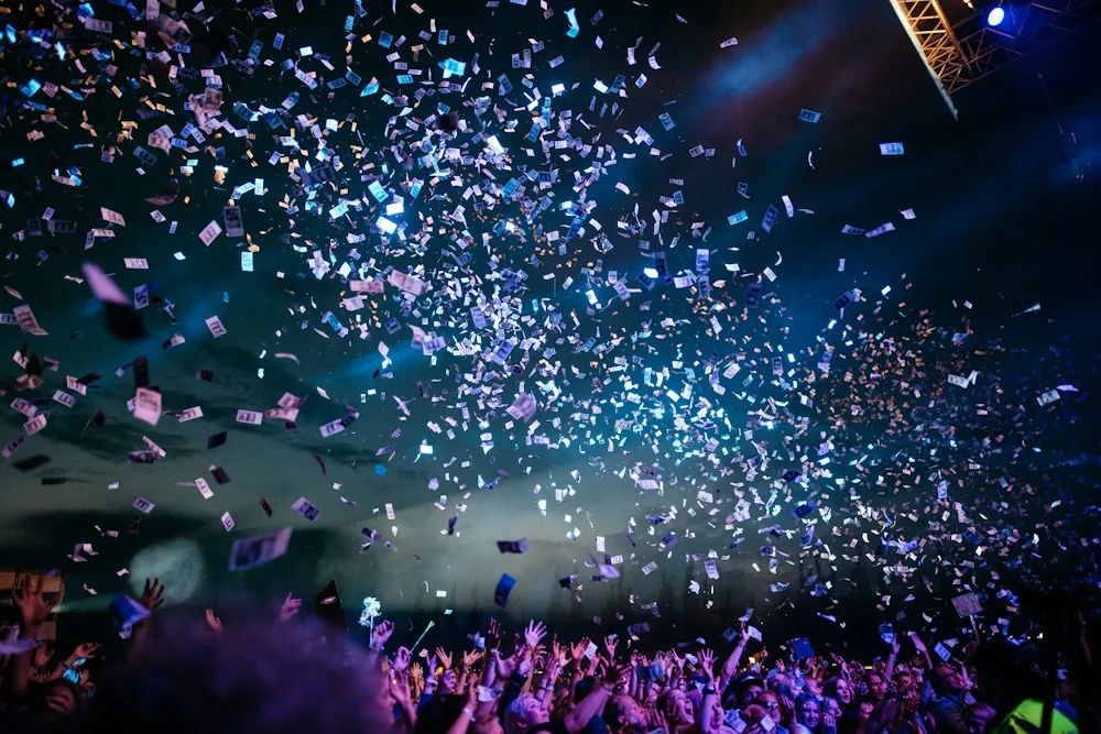 Confetti drifting above a live stage
