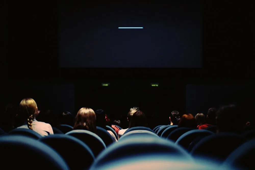 Audience seated in a dark cinema